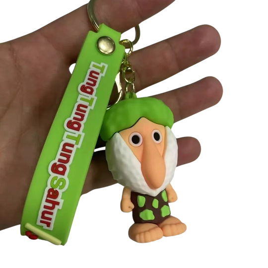 Keychain with a character and green tag held in a hand against a white background