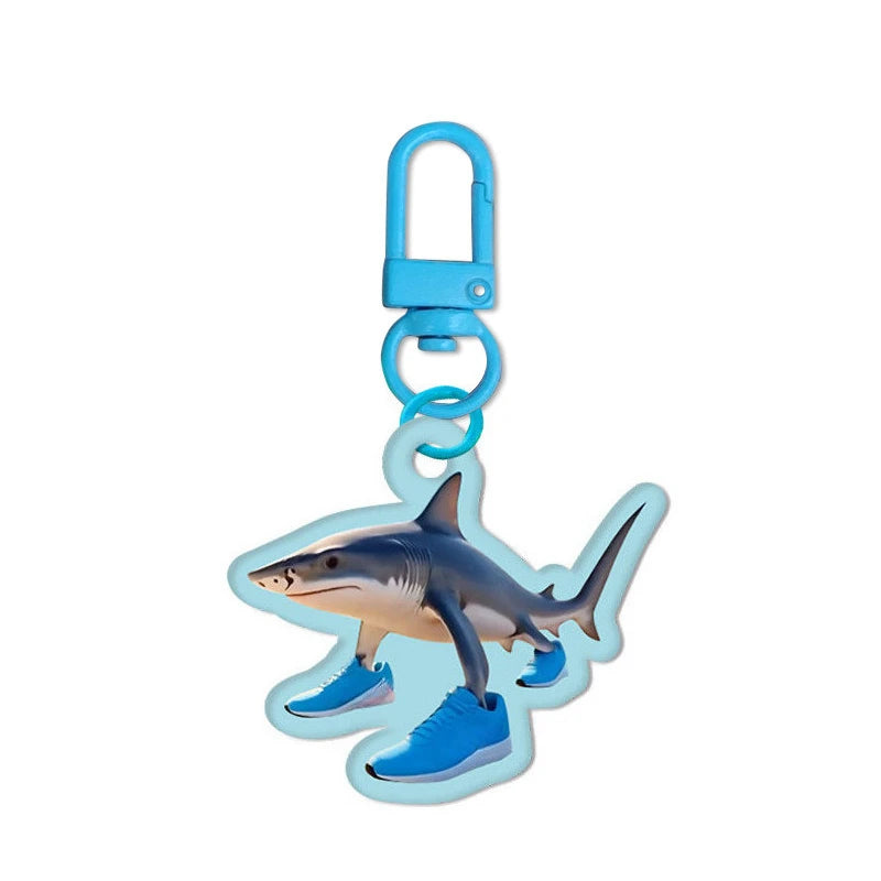 Shark-shaped keychain with blue accents on a white background