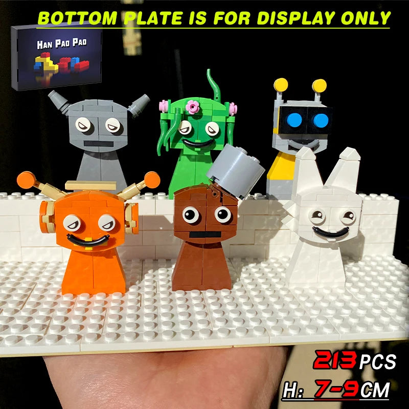 Set of colorful toy robots on a display base with text indicating 'Bottom plate is for display only'.