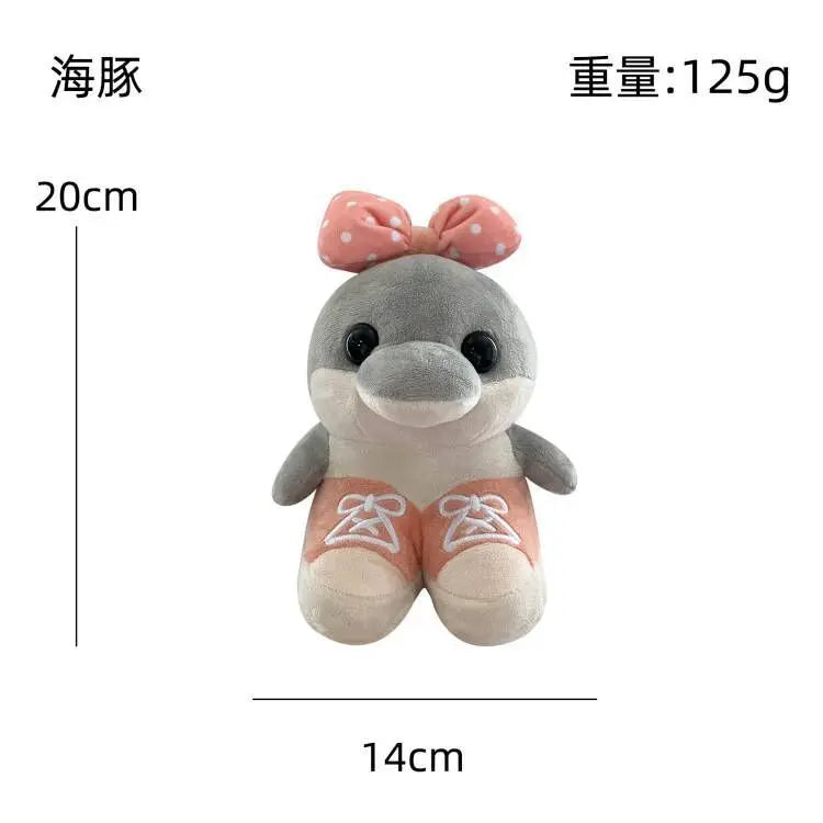 Plush toy dolphin with a pink bow and measurements on a white background
