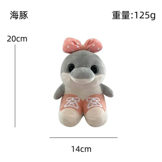 Plush toy dolphin with a pink bow and measurements on a white background