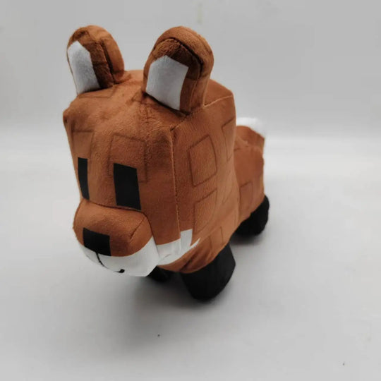 Plush toy resembling a fox on a white background
