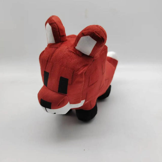 Red plush toy resembling a fox on a white background