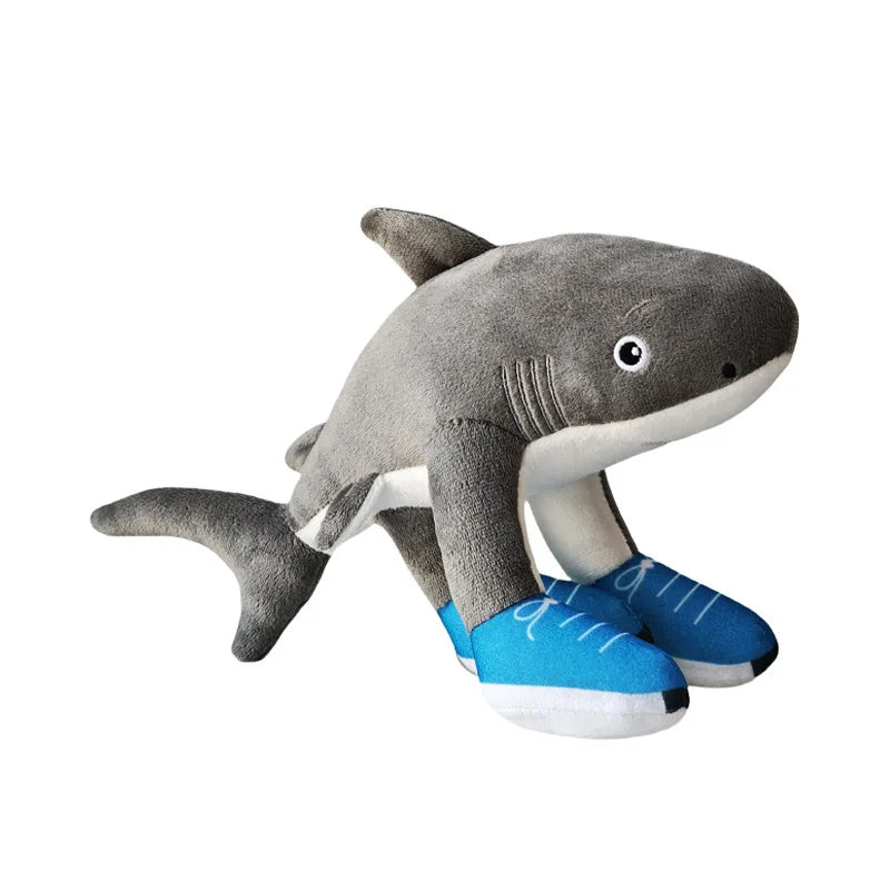 Plush shark toy with blue shoes on a white background