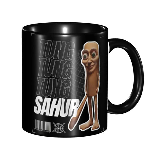 Black mug with cartoon sloth standing upright next to bold white text "SAHUR" on a shaded background. The tone is playful and humorous.