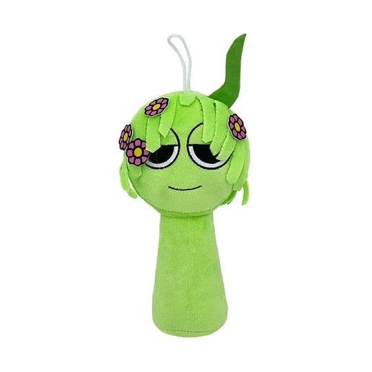 Green plush toy with flower decorations on a white background