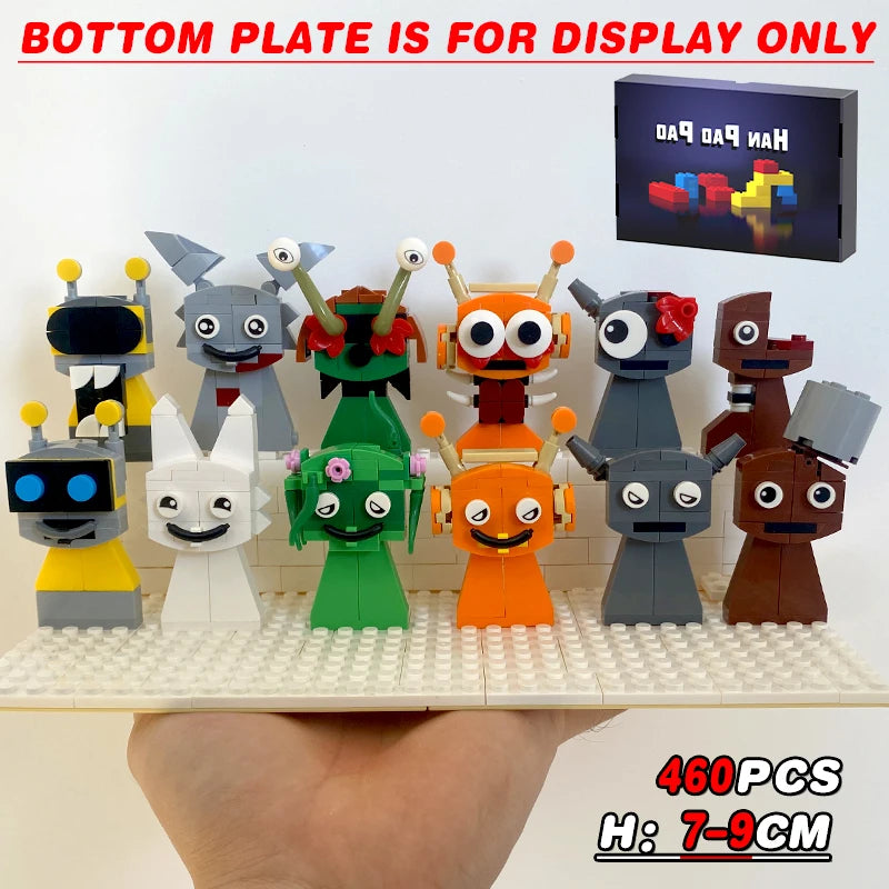 Set of colorful robot toy figures on a display base with a small screen showing text.